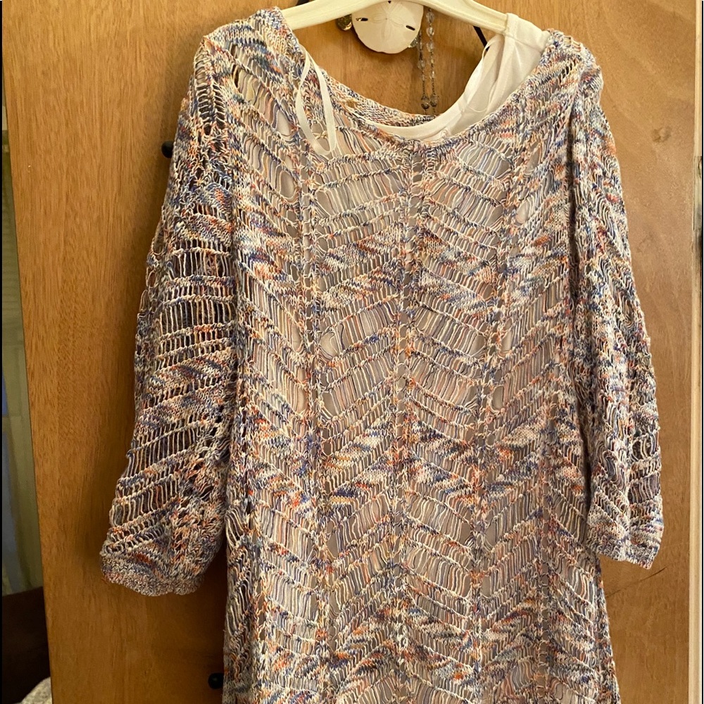 Crocheted sweater with white tank top lining